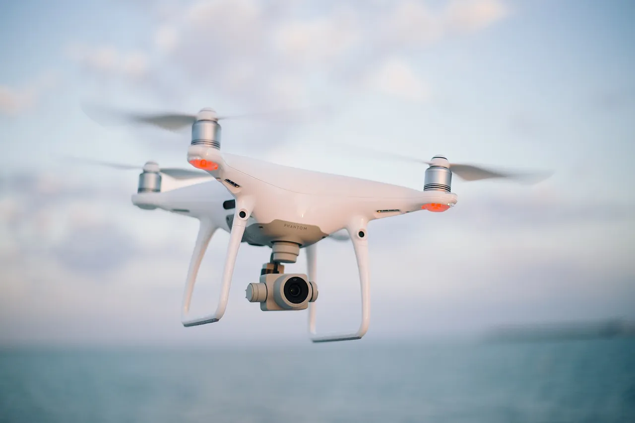 A quadcopter drone flying over water
