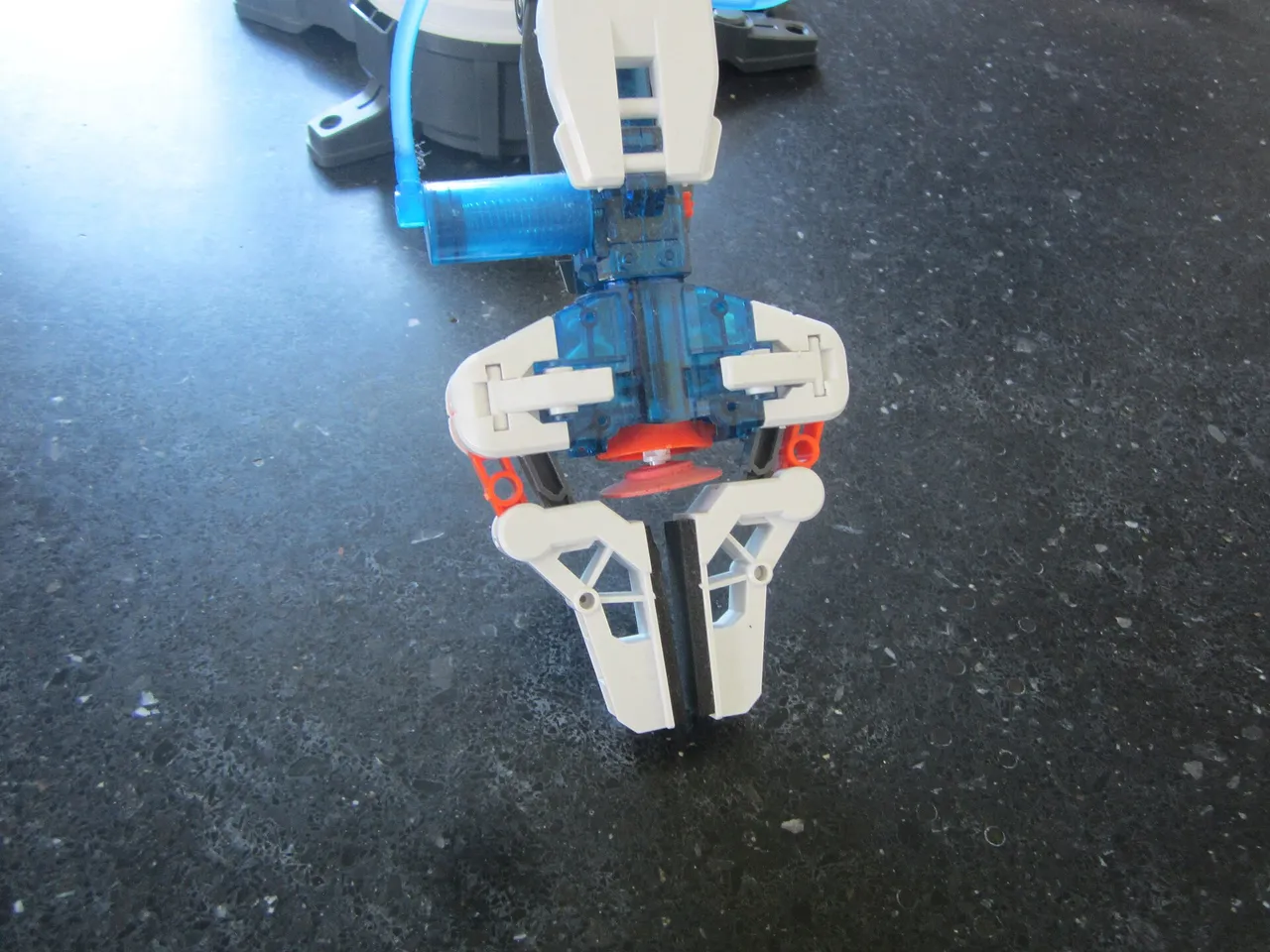 A toy robotic arm gripper opening its claws